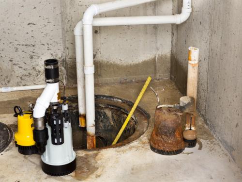 A sump pump in a basement being replaced.