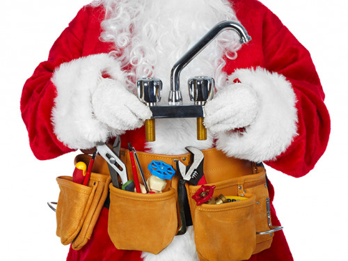 Santa wearing a tool belt and holding a faucet.